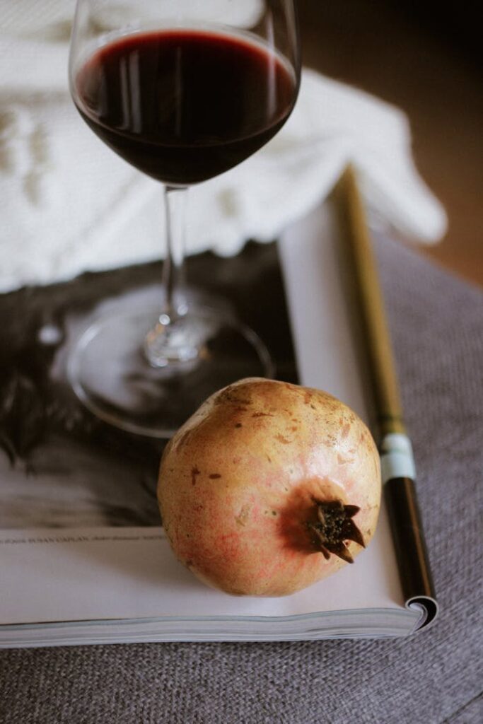 pexels-photo-28991545 Elegant Still Life with Wine and Pomegranate